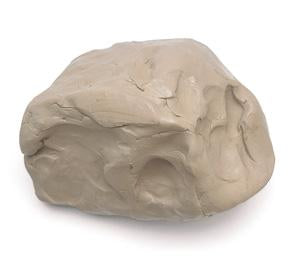 A large off-white clump of wet clay against white background.